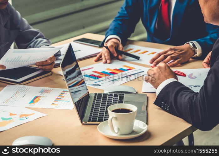 Smart businessman and businesswoman talking discussion in group meeting at office table in a modern office interior. Business collaboration strategic planning and brainstorming of coworkers.