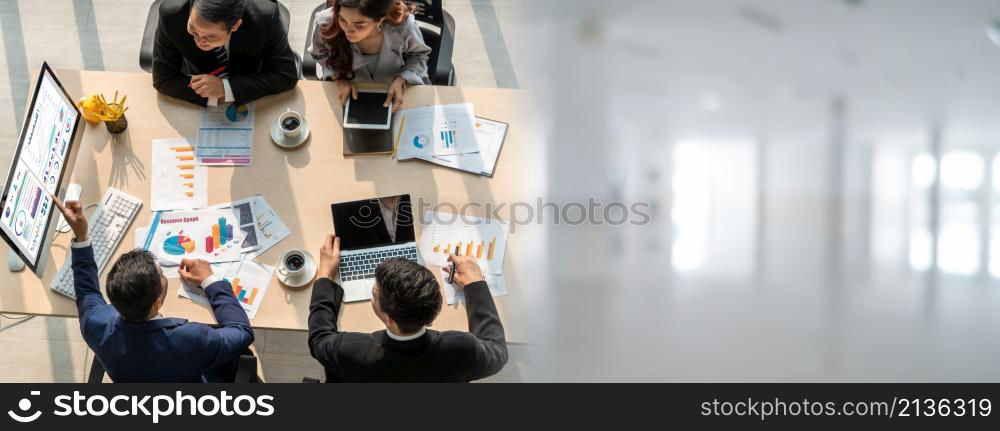 Smart businessman and businesswoman talking discussion in widen group meeting at office table in a modern office interior. Business collaboration strategic planning and brainstorming of coworkers.. Smart businessman and businesswoman talking discussion in widen group meeting