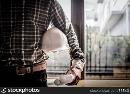 Smart Businessman holding construction helmet and blueprints in retro style.