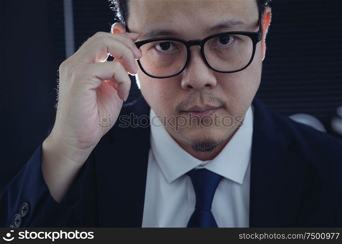 Smart businessman in suit and eyeglasses looking at camera . Closeup view .