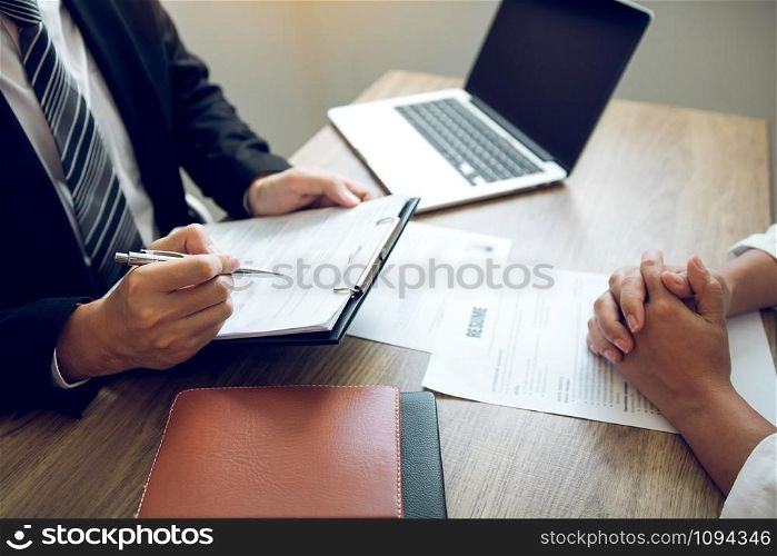 Smart businessman professional man in suit executive gesturing and talking in meeting with interview employee women about work in modern office.