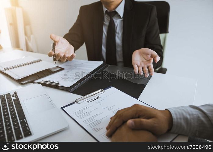 Smart businessman professional man in suit executive gesturing and talking in meeting with employee about work in modern office.