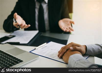 Smart businessman professional man in suit executive gesturing and talking in meeting with employee about work in modern office.