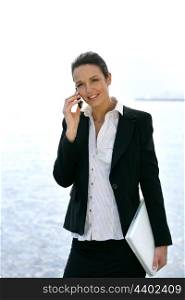 Smart businesswoman on cellphone outdoors