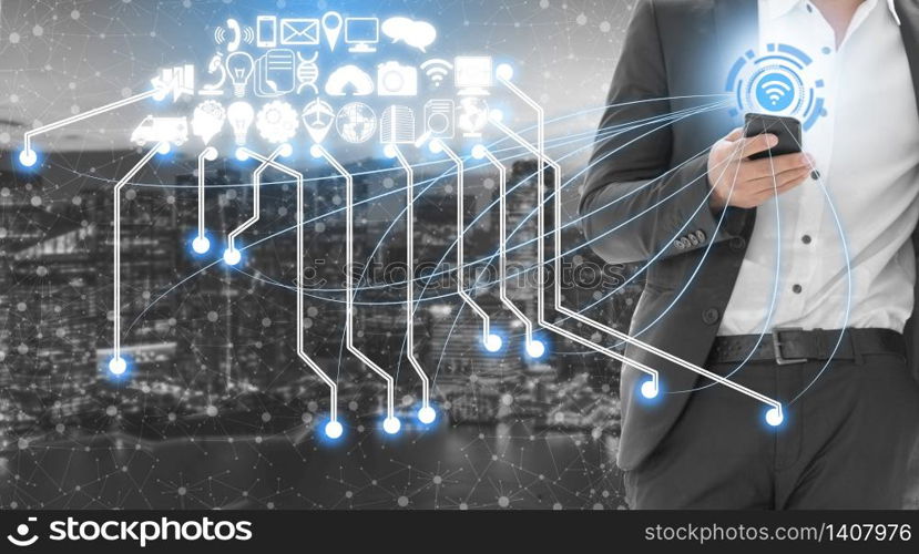 Smart city wireless communication network with graphic showing concept of internet of things ( IOT ) and information communication technology ( ICT ) against modern city buildings in the background.. Smart city and wireless communication network.