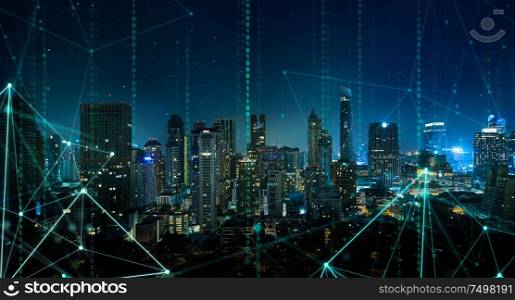 Smart city with wireless network and 5g connection technology . Bangkok city background at night .