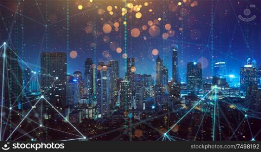 Smart city with wireless network and 5g connection technology . Bangkok city background at night .