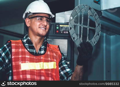 Smart factory job worker looking at machine part in manufacturing workshop . Industry and engineering technology concept .. Smart factory job worker looking at machine part in manufacturing workshop