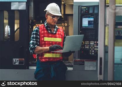 Smart factory worker or engineer do machine job in a manufacturing workshop . Industry and engineering concept .