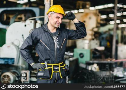 smart handsome European Russian worker happy working in factory with yellow helmet and safety suit portrait standing at heavy industry workplace.