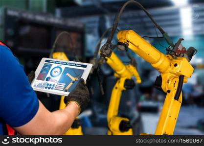 Smart industry robot arms for digital factory production technology showing automation manufacturing process of the Industry 4.0 or 4th industrial revolution and IOT software to control operation .