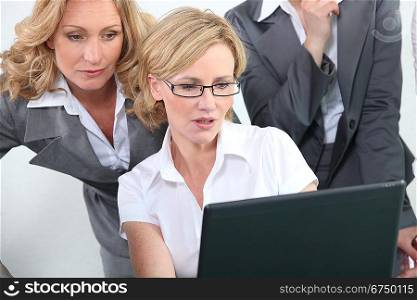 Smart intelligent businesswomen looking at a laptop