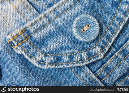 Smart jeans button in classic and pale color. Blue jeans fabric pocket.