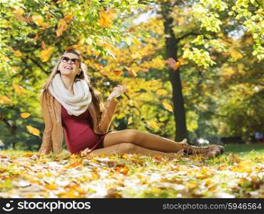 Smart lady watching gold autumn leaves