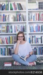 smart looking famale student girl in collage school library reading book