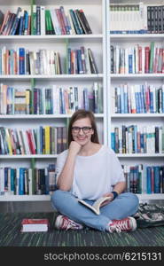 smart looking famale student girl in collage school library reading book