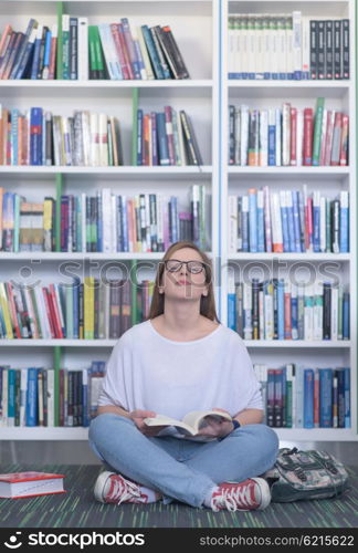 smart looking famale student girl in collage school library reading book