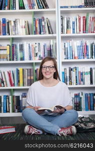 smart looking famale student girl in collage school library reading book