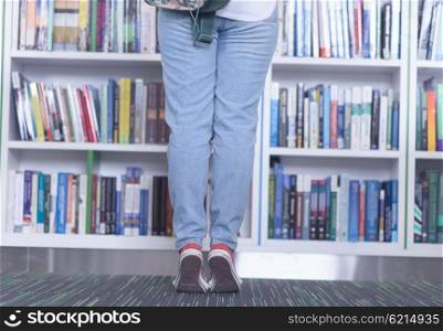 smart looking famale student girl in collage school library selecting book to read