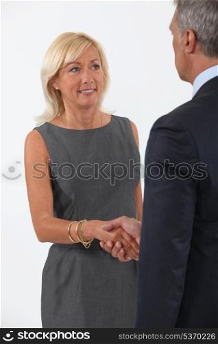 Smart man and woman handshaking