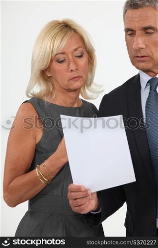 Smart man and woman reading a document