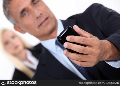 Smart man taking picture with mobile phone
