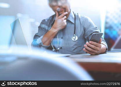 smart medical doctor hand working with smart phone,digital tablet computer,stethoscope eyeglass,on wood desk,filter effect