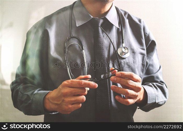 smart medical doctor holding eyeglass,stethoscope ,front view,filter effect