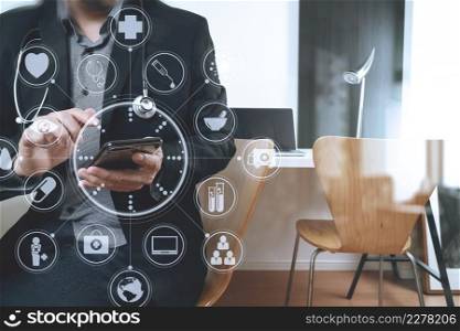 smart medical doctor working with smart phone and digital tablet and laptop computer on dark wooden desk in modern office with virtual icon diagram