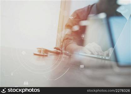 smart medical doctor working with stethoscope and laptop and digital tablet computer on dark wooden desk with Vr diagram