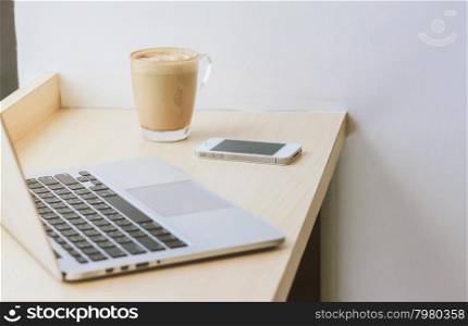 Smart phone and laptop with coffee cup at home or cafe &#xD;