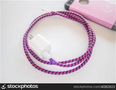 Smart phone charger with plastic cover on white background, stock photo