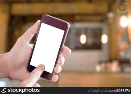 Smart phone in woman hand with coffee shop blurred abstract background