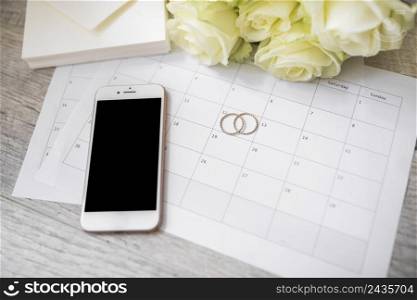 smart phone wedding rings envelope roses calendar wooden plank