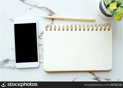 Smart phone with blank screen on blank notebook paper background, mock up, flat lay