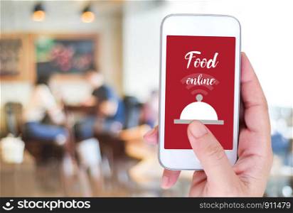 Smart phone with food online device on screen over blur restaurant background, food online, food delivery concept