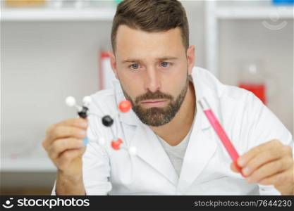 smart professional researcher studying a dna model