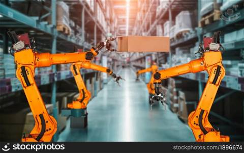Smart robot arm system for innovative warehouse and factory digital technology . Automation manufacturing robot controlled by industry engineering using IOT software connected to internet network .. Smart robot arm system for innovative warehouse and factory digital technology