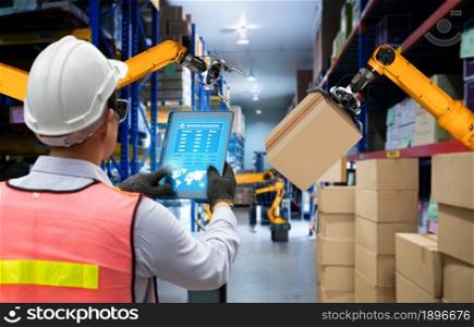 Smart robot arm systems for innovative warehouse and factory digital technology . Automation manufacturing robot controlled by industry engineering using IOT software connected to internet network .. Smart robot arm systems for innovative warehouse and factory digital technology
