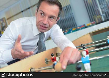 smart salesman demonstrating table football game