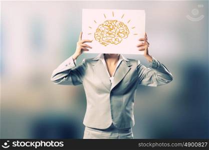 Smart thinking. Businesswoman hiding her face behind paper sheet
