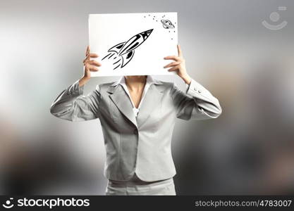 Smart thinking. Businesswoman hiding her face behind paper sheet with sketches