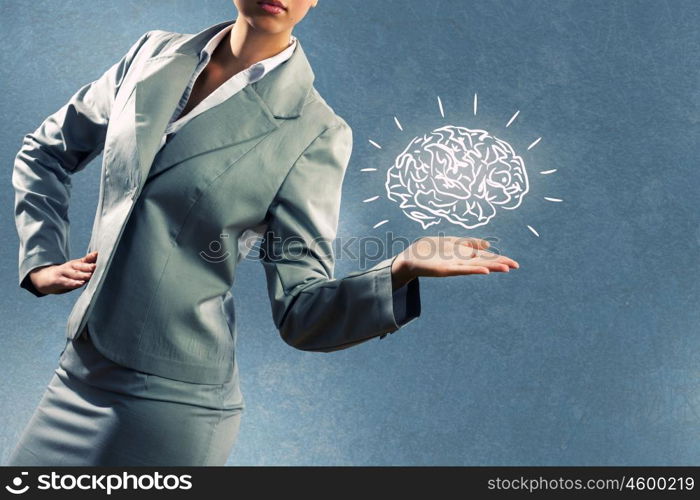 Smart thinking. Close up of business woman holding human brain in hand