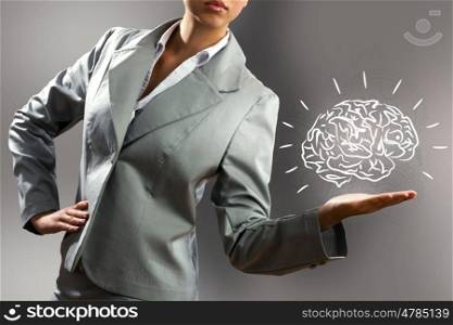 Smart thinking. Close up of business woman holding human brain in hand