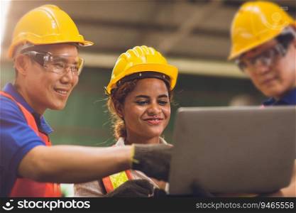 smart woman engineer working around with men team mix race work together in heavy industry looking and discussion problem on laptop computer.