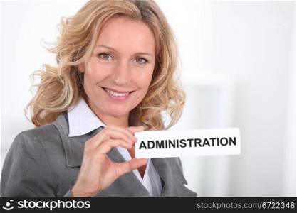 Smart woman holding a sign entitled &rsquo;ADMINISTRATION&rsquo;