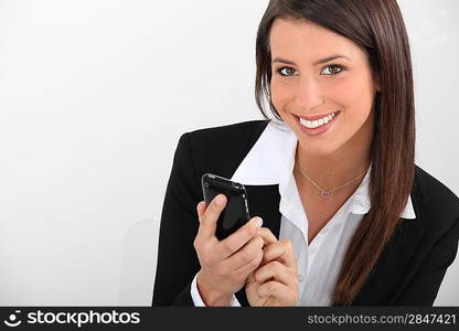 Smart young businesswoman using a smartphone