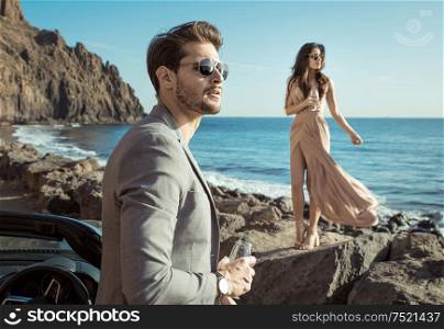 Smart, young couple relaxing by the sea