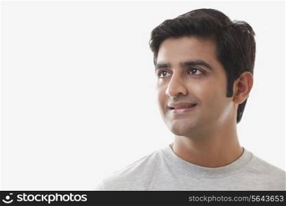 Smart young man smiling over white background