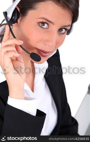 Smart young woman wearing a telephone headset